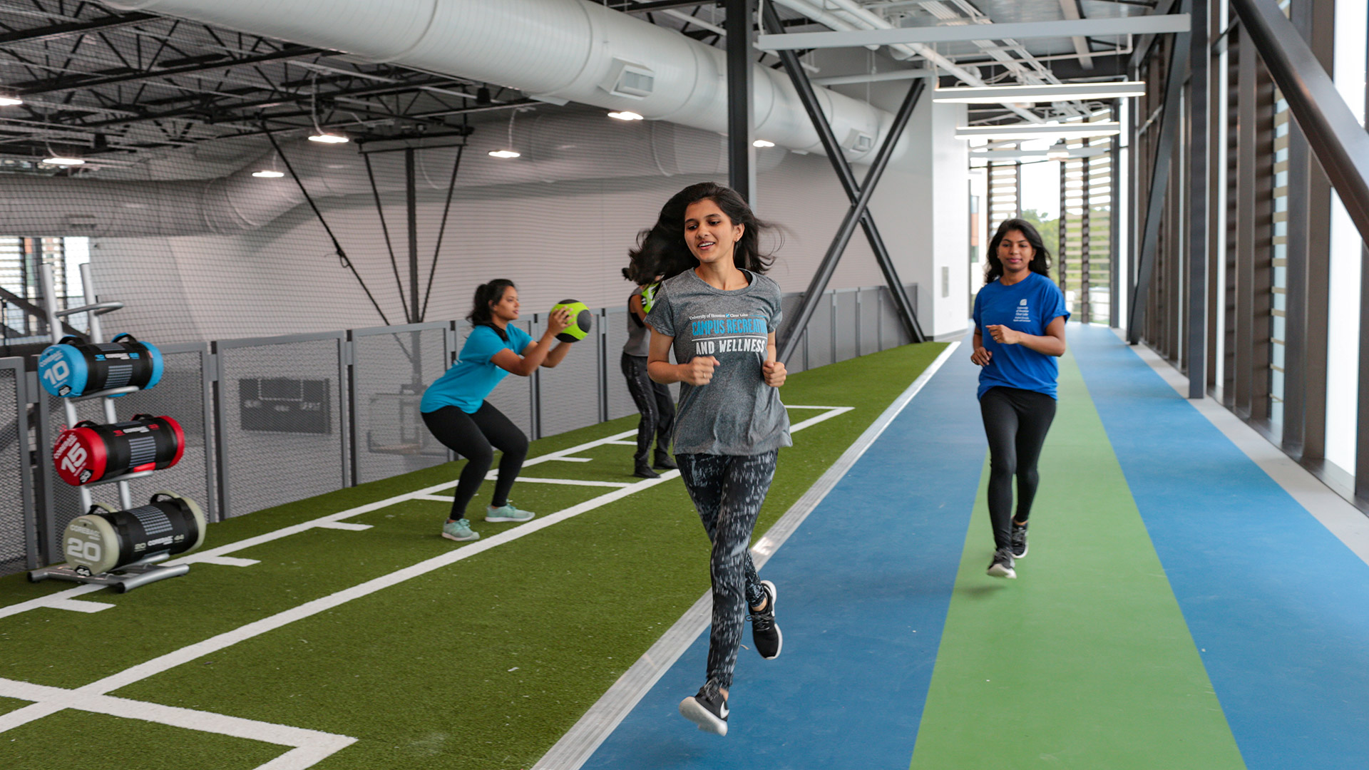Students running on the Recreation and Wellness Center indoor track.